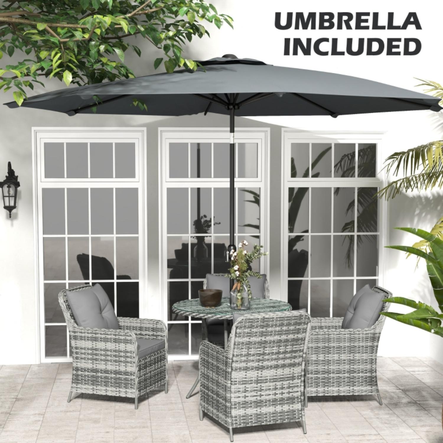 Outdoor patio set with umbrella in front of a glass door.