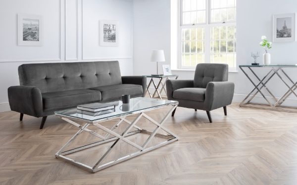 Modern living room with gray sofa, armchair, and glass coffee table.