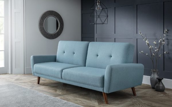 Blue sofa in a room with gray walls and decorative elements.