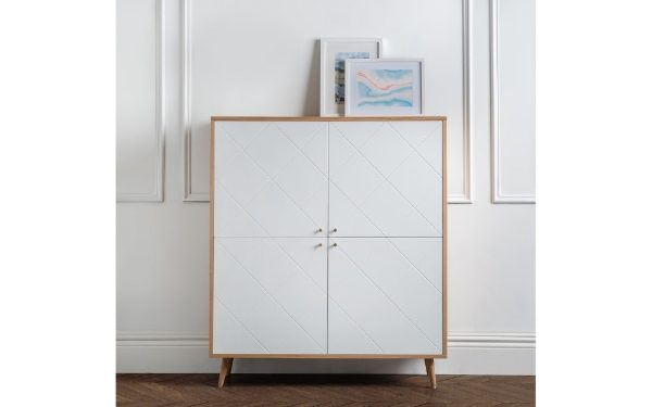 White cabinet with wooden frame against a white wall