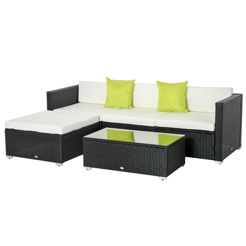 Outdoor furniture set with black wicker frame, white cushions, and green pillows on a white background.