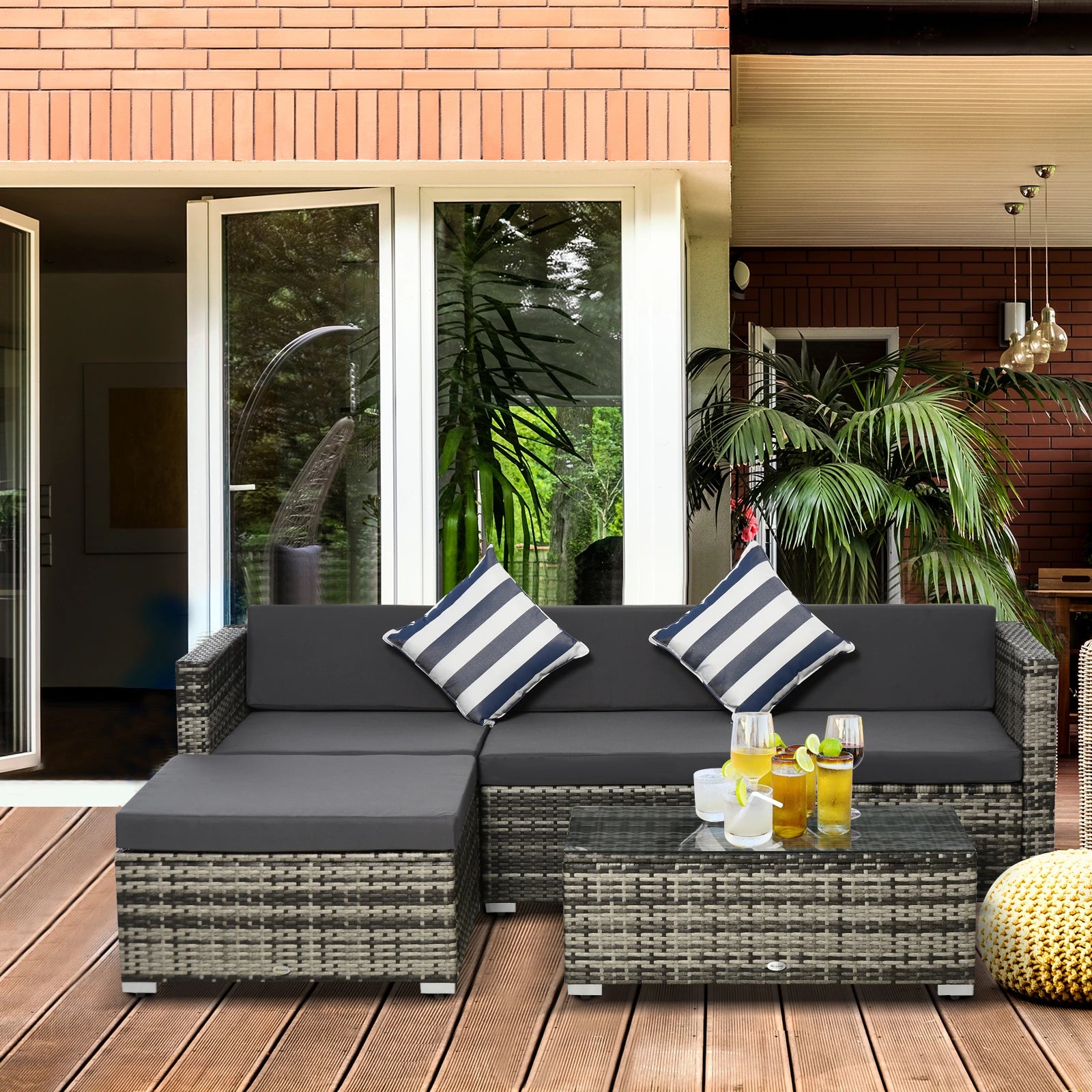 Outdoor patio set with a sectional sofa and coffee table on a wooden deck.