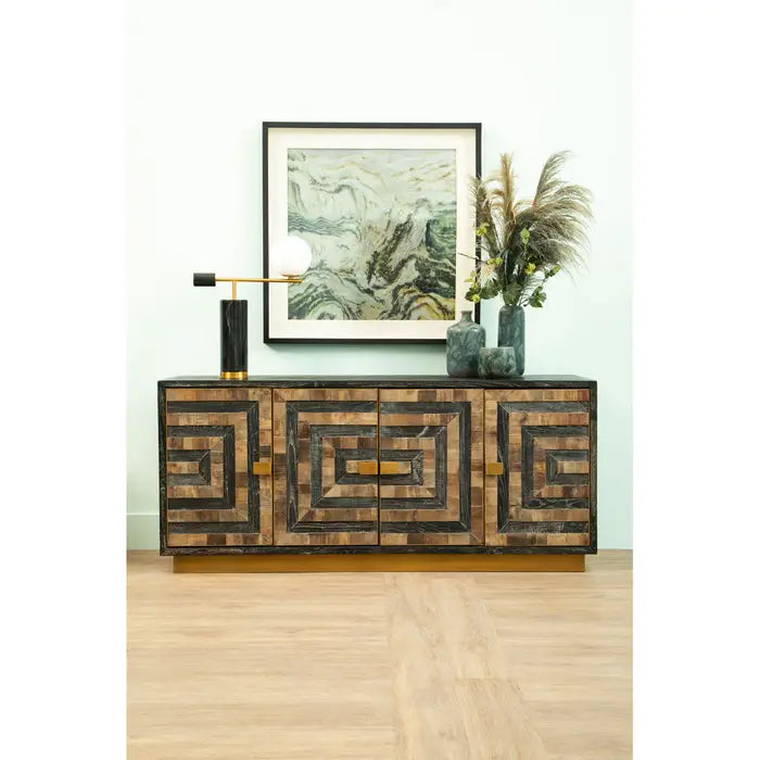 Wooden sideboard with decorative items and a framed abstract painting in a room.