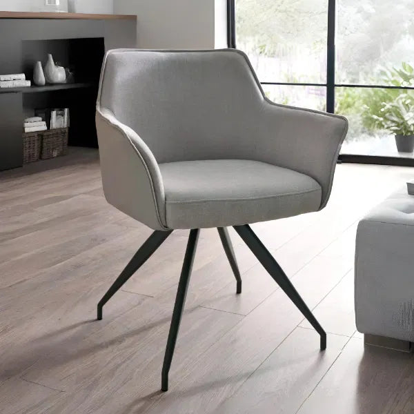 Gray armchair with black legs in a modern living room setting