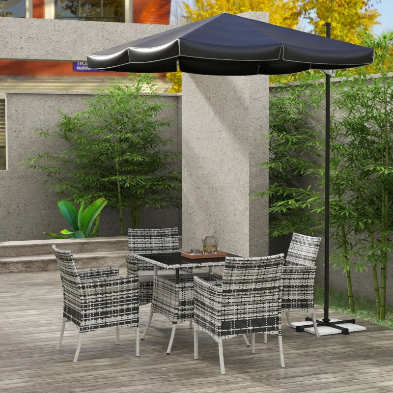 Outdoor patio set with table and chairs under a large black umbrella on a wooden deck.