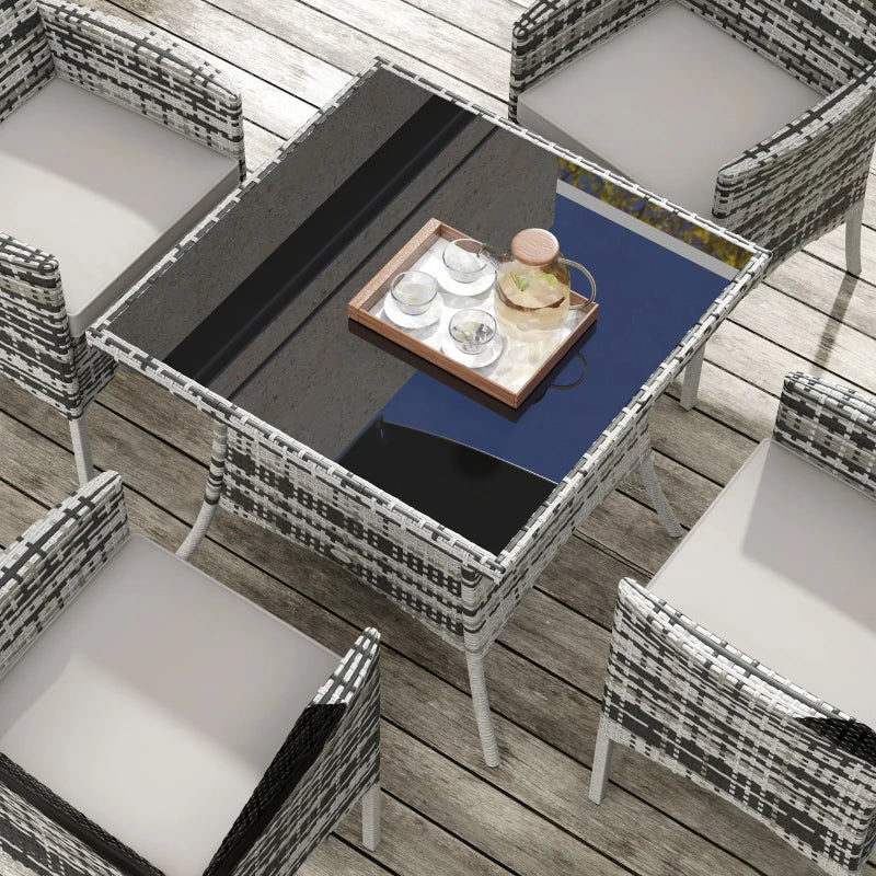 Outdoor furniture set with a table and chairs on a wooden deck.