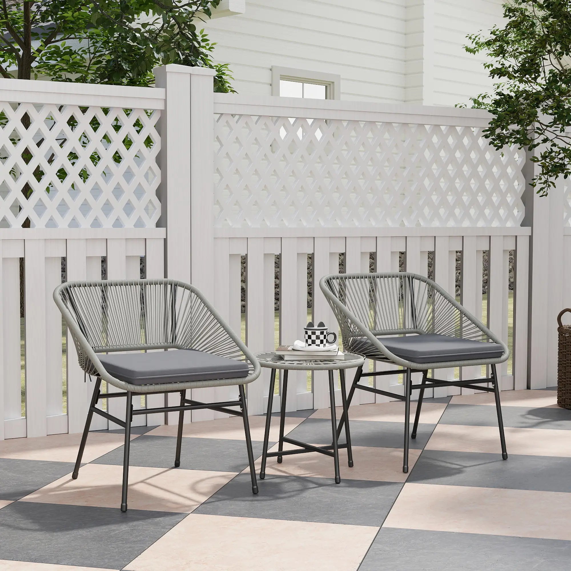 Outdoor patio set with two chairs and a table on a checkered patio floor.