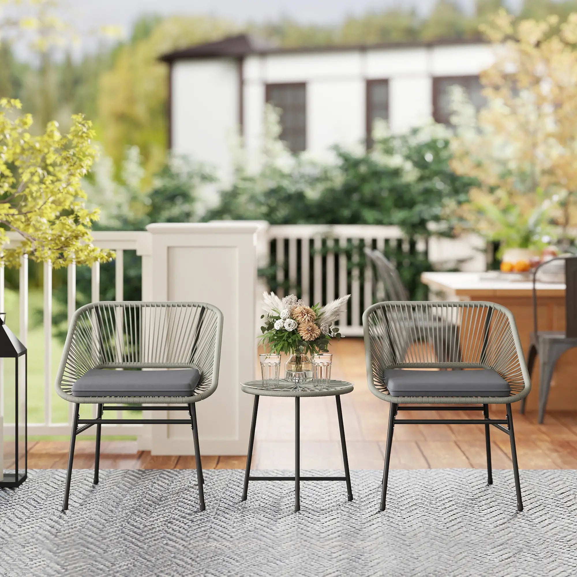 Outdoor patio set with two chairs and a small table on a deck.