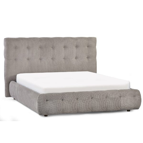 Gray upholstered bed with tufted design on a white background