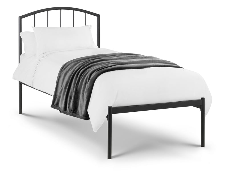 Black metal bed frame with white bedding