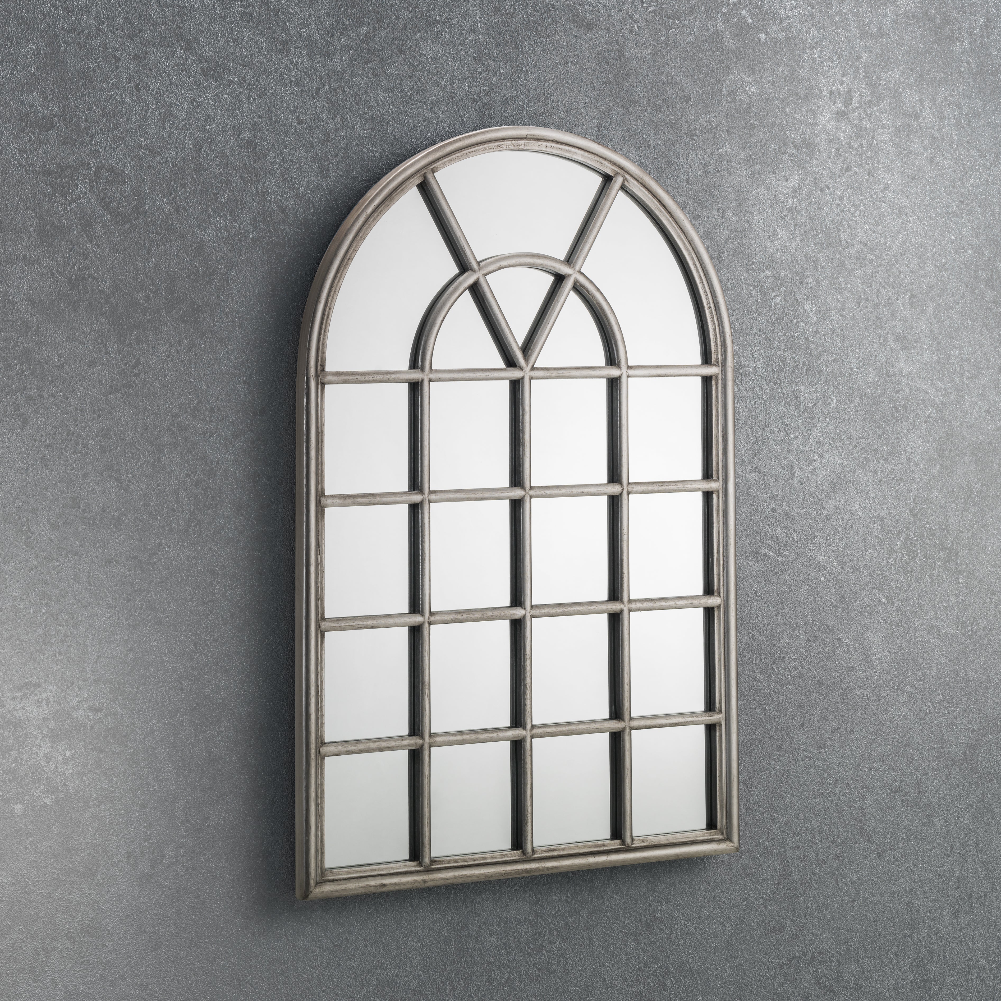 Decorative wall mirror with a window-like design on a gray wall