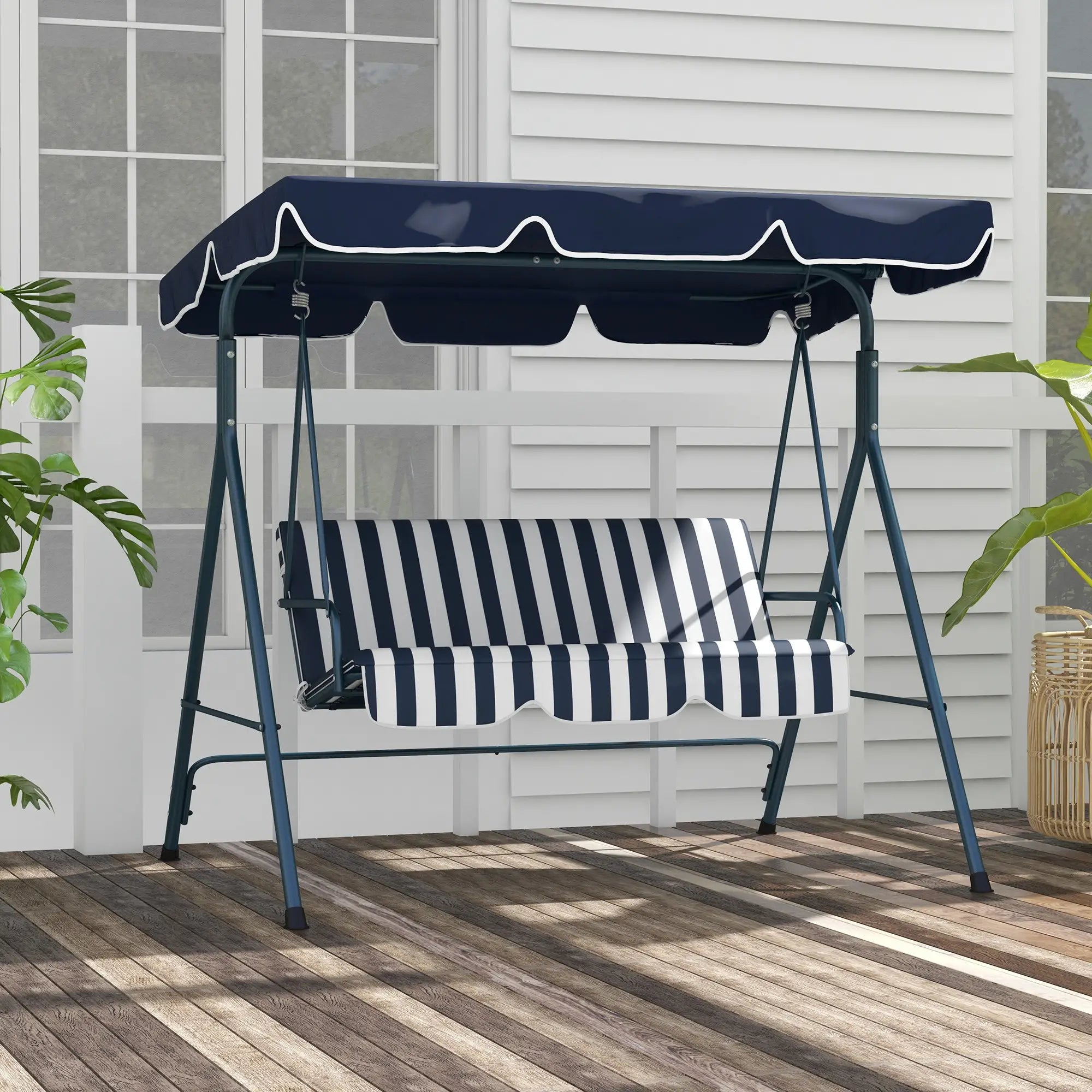 Navy and white striped swing with canopy on a wooden deck