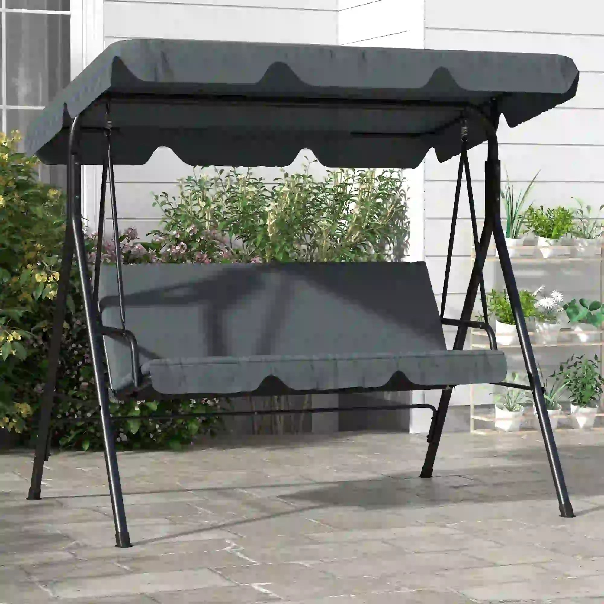 Gray outdoor swing with canopy on a wooden deck