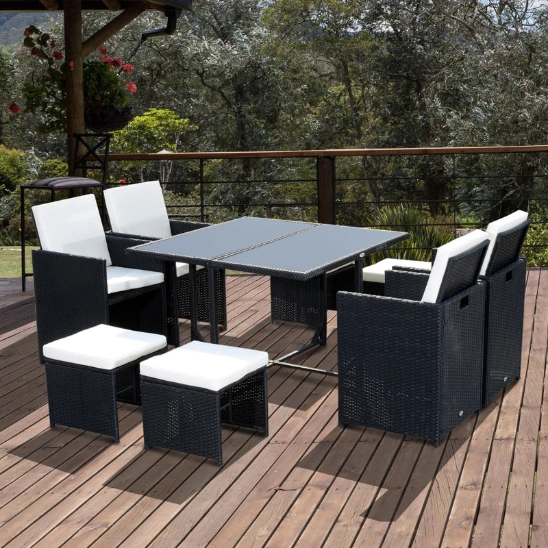 Outdoor patio set with black wicker furniture and white cushions on a wooden deck.