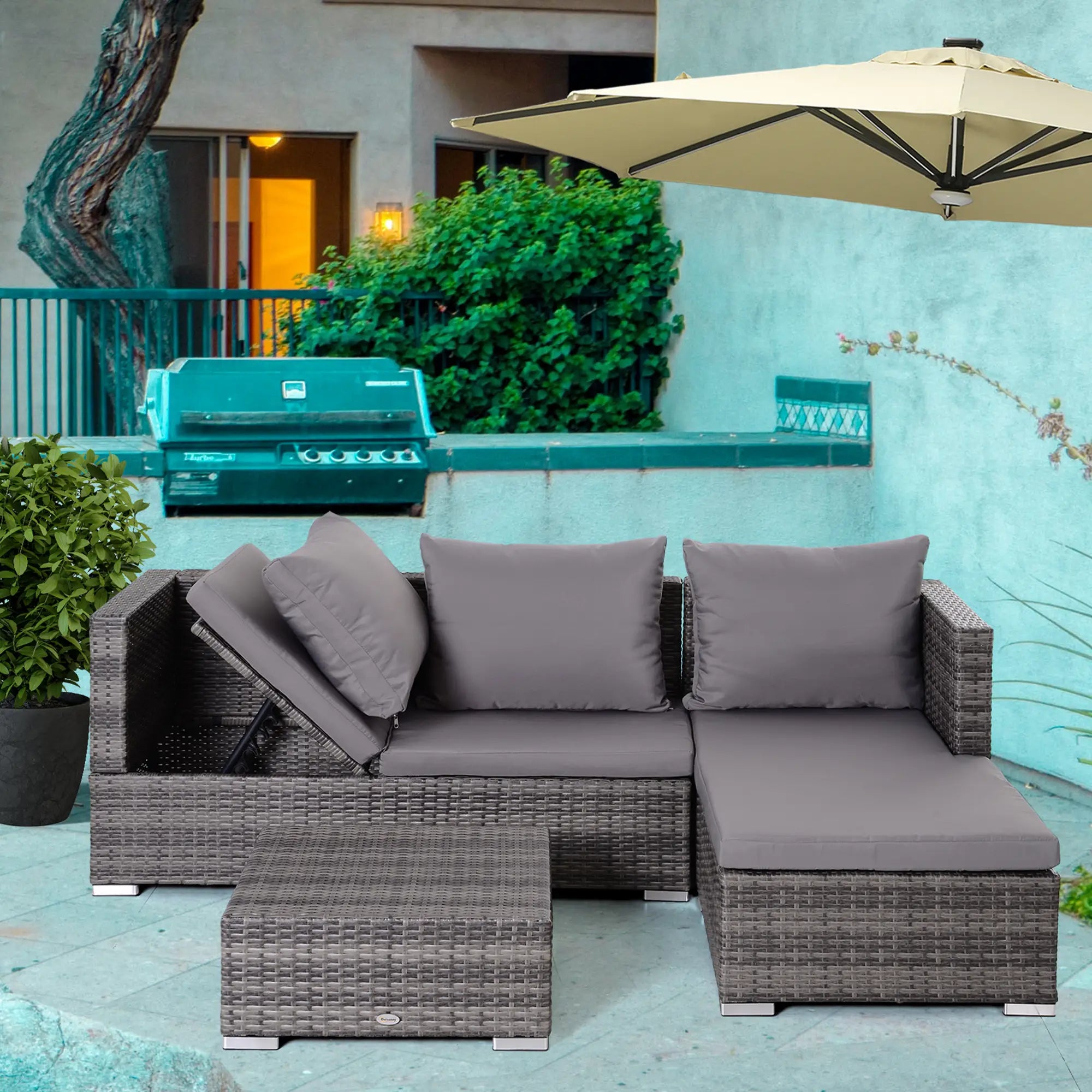 Gray outdoor sectional sofa with cushions on a patio with a grill and umbrella in the background.