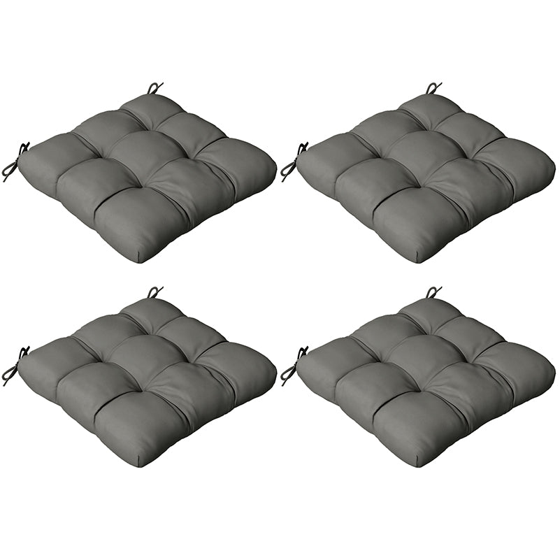 Four gray cushioned chair pads on a white background