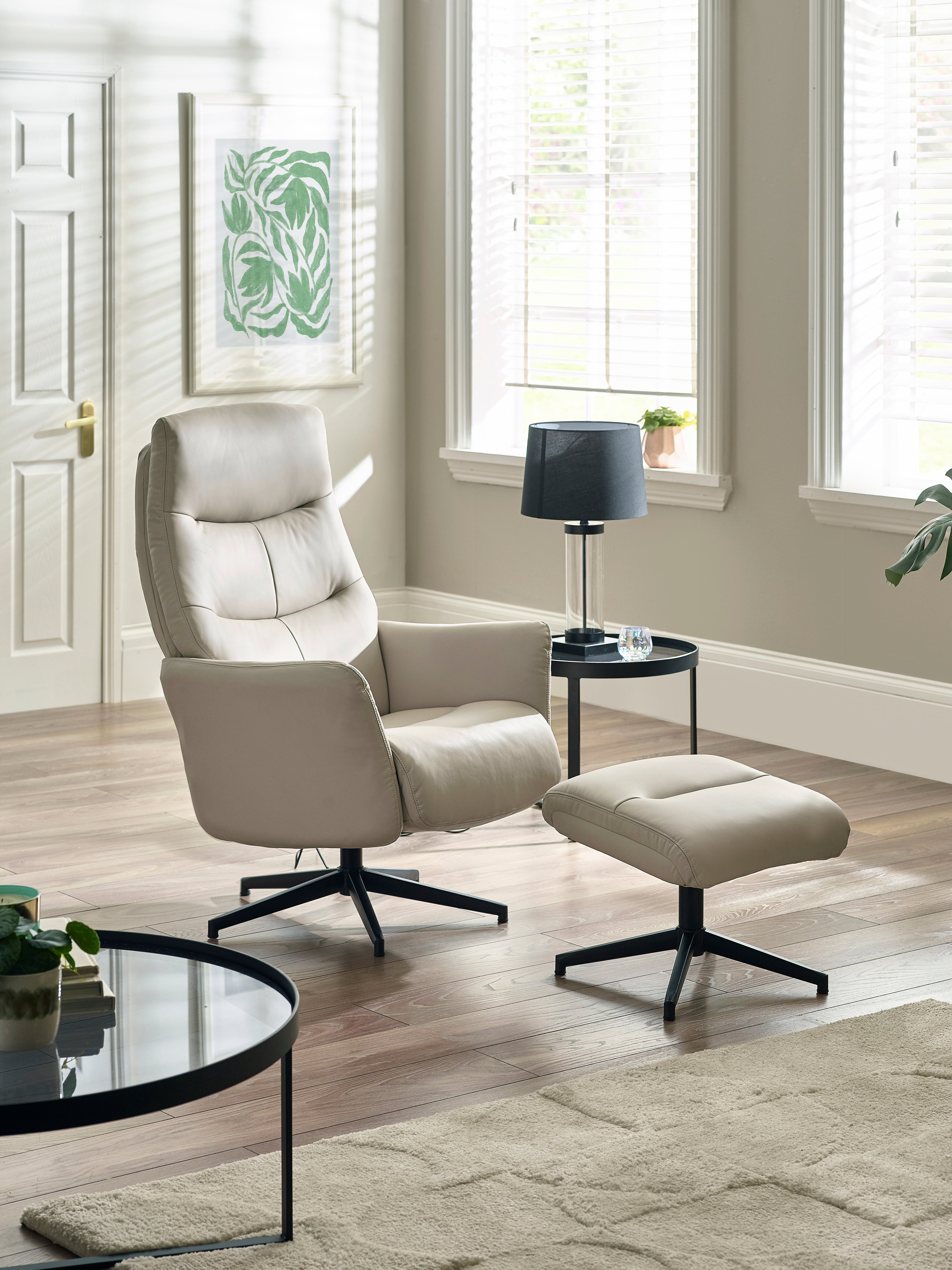 Beige armchair with ottoman in a living room setting