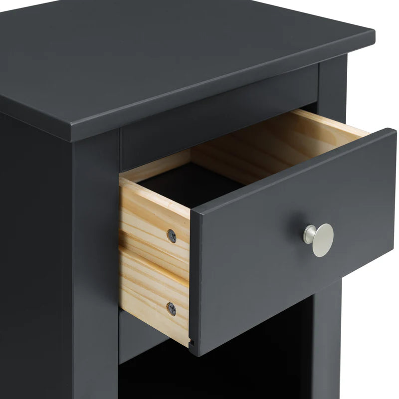 Black nightstand with a single drawer open on a white background