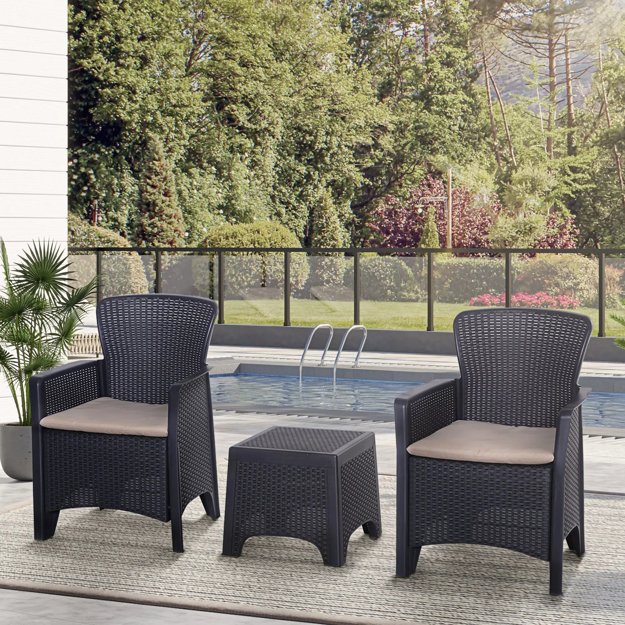 Outdoor patio set with two chairs and a table by a poolside.