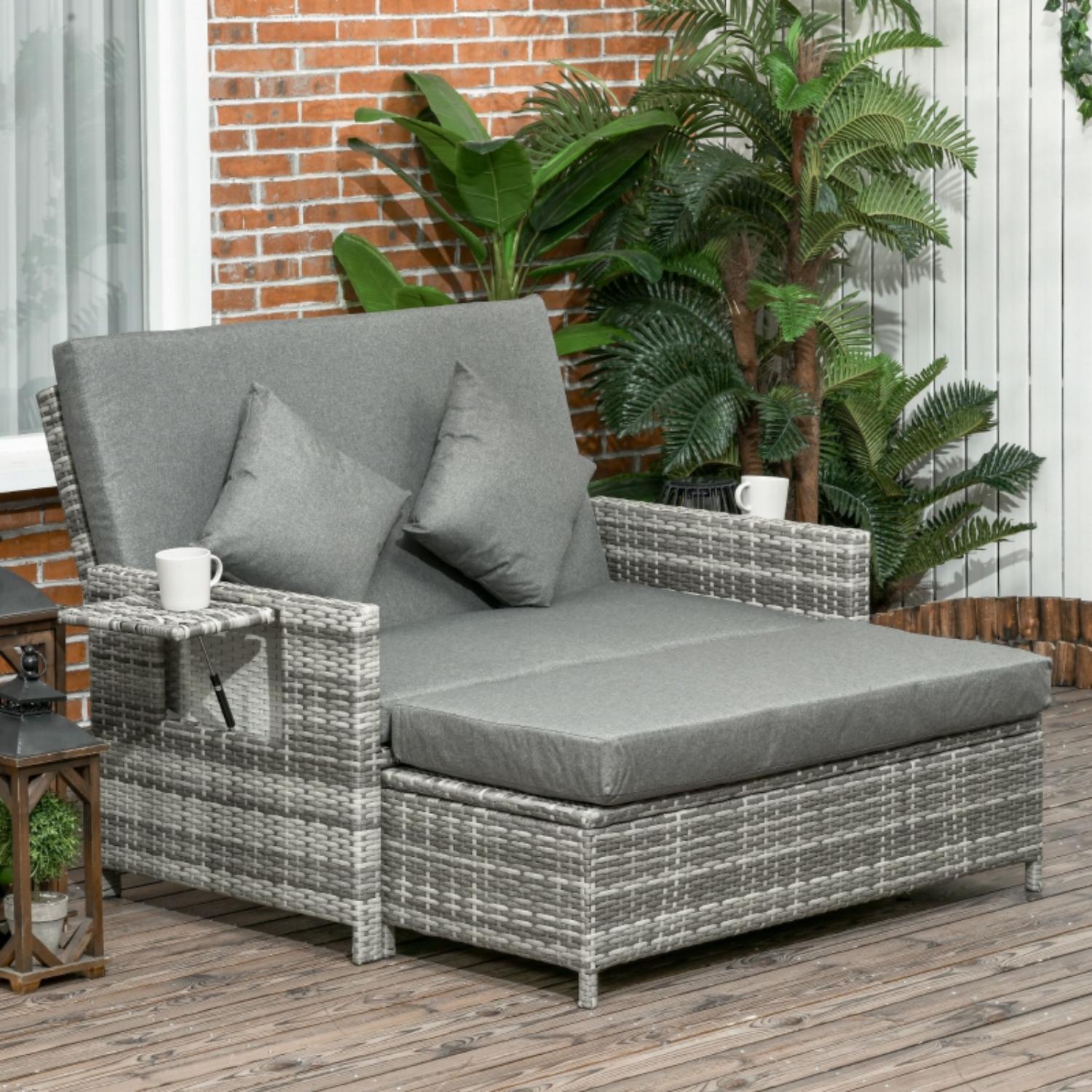 Gray outdoor lounge chair with cushions on a wooden deck.