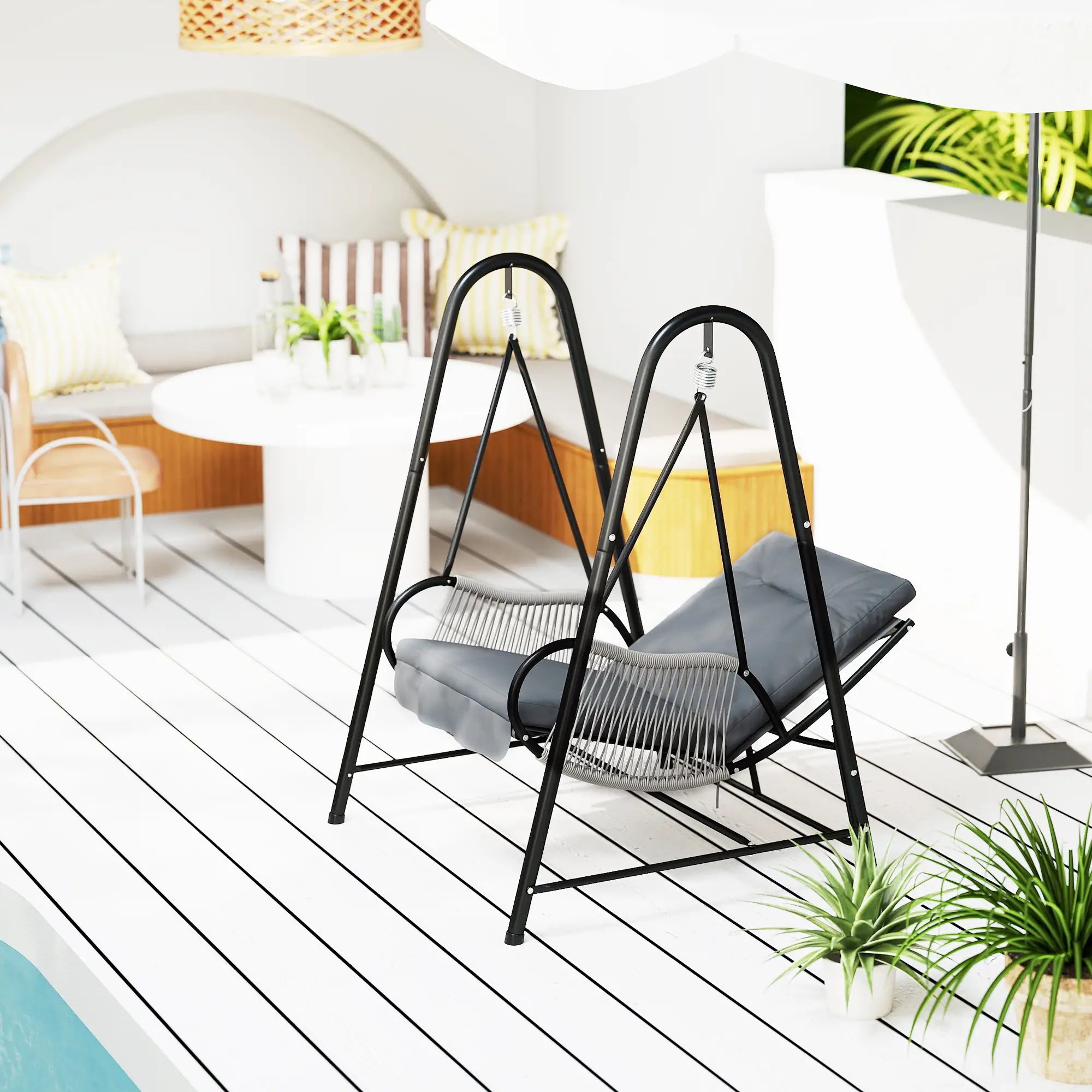 Black metal swing with gray cushion on a white deck