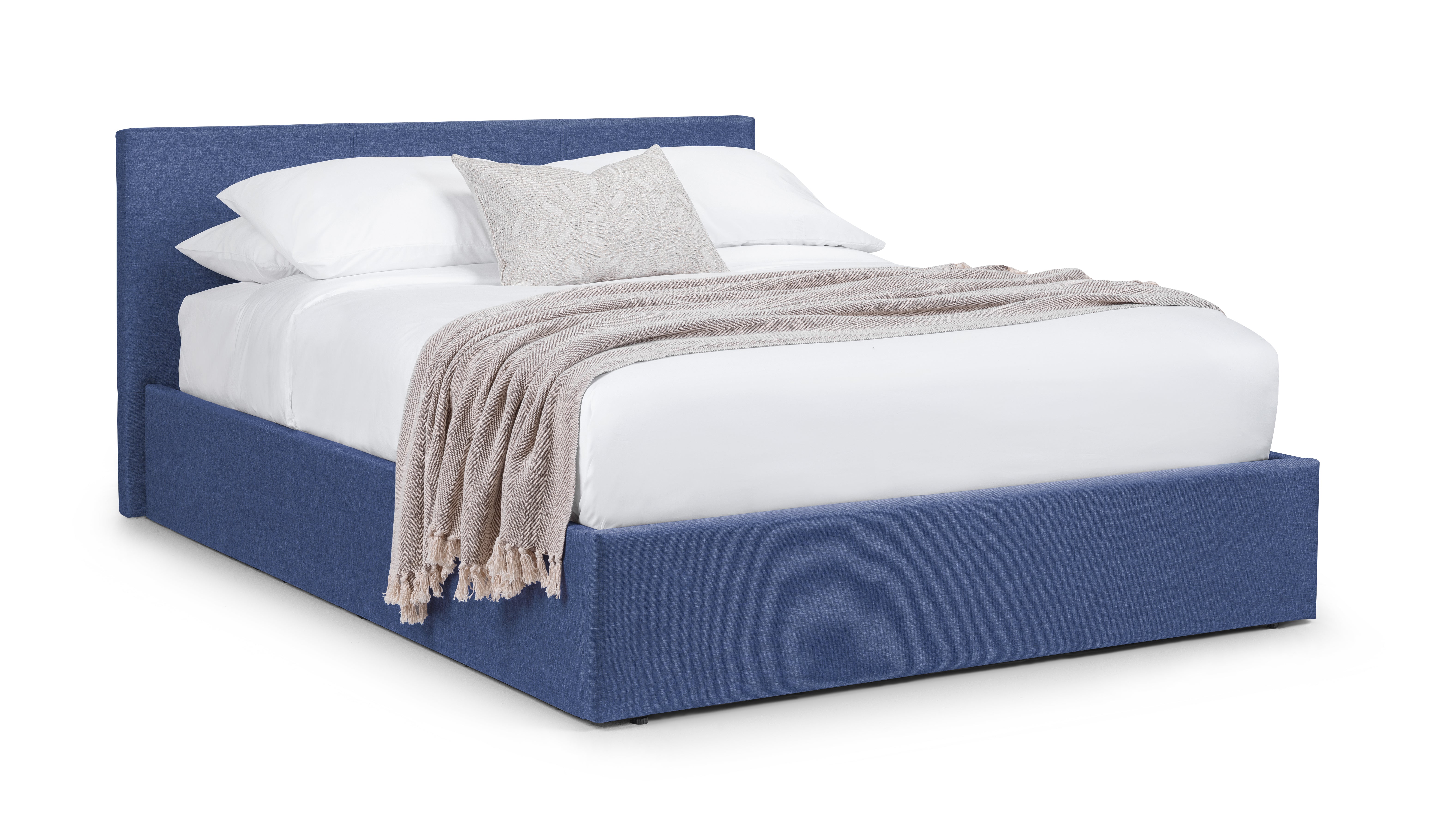 Blue upholstered bed with white bedding and a beige blanket on a white background