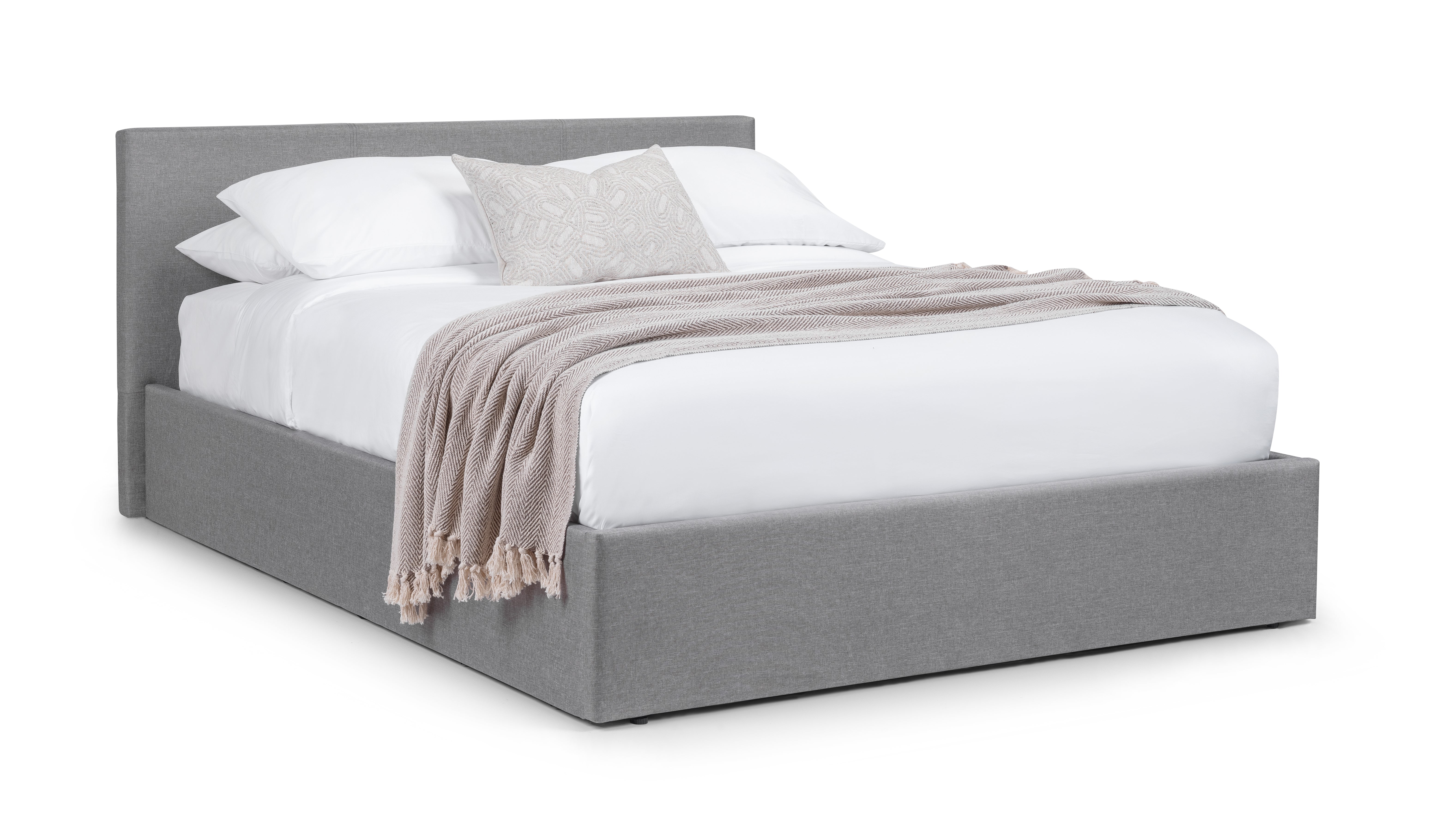 Gray upholstered bed with white bedding and a beige blanket on a white background
