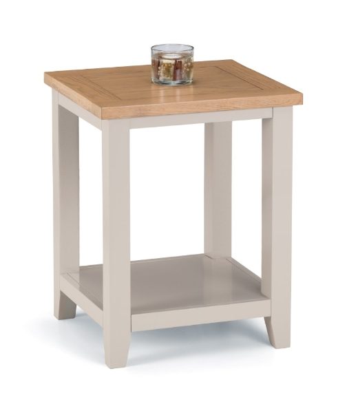 Small wooden side table with a glass of water on a white background