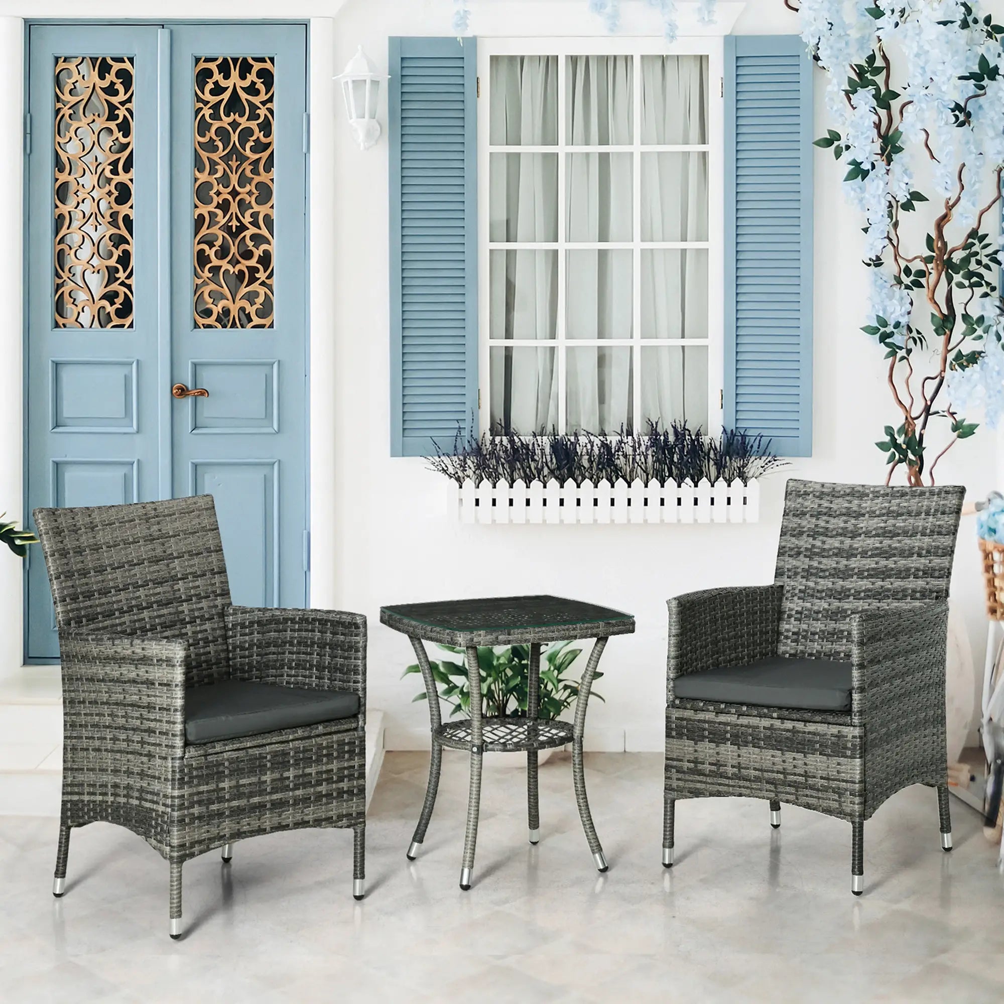 Outdoor furniture set with two chairs and a table in front of a blue door and window.