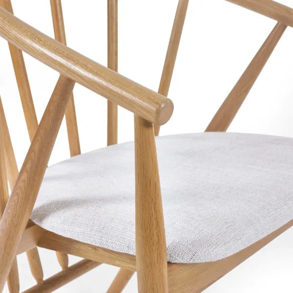 Wooden chair with a grey cushion on a white background