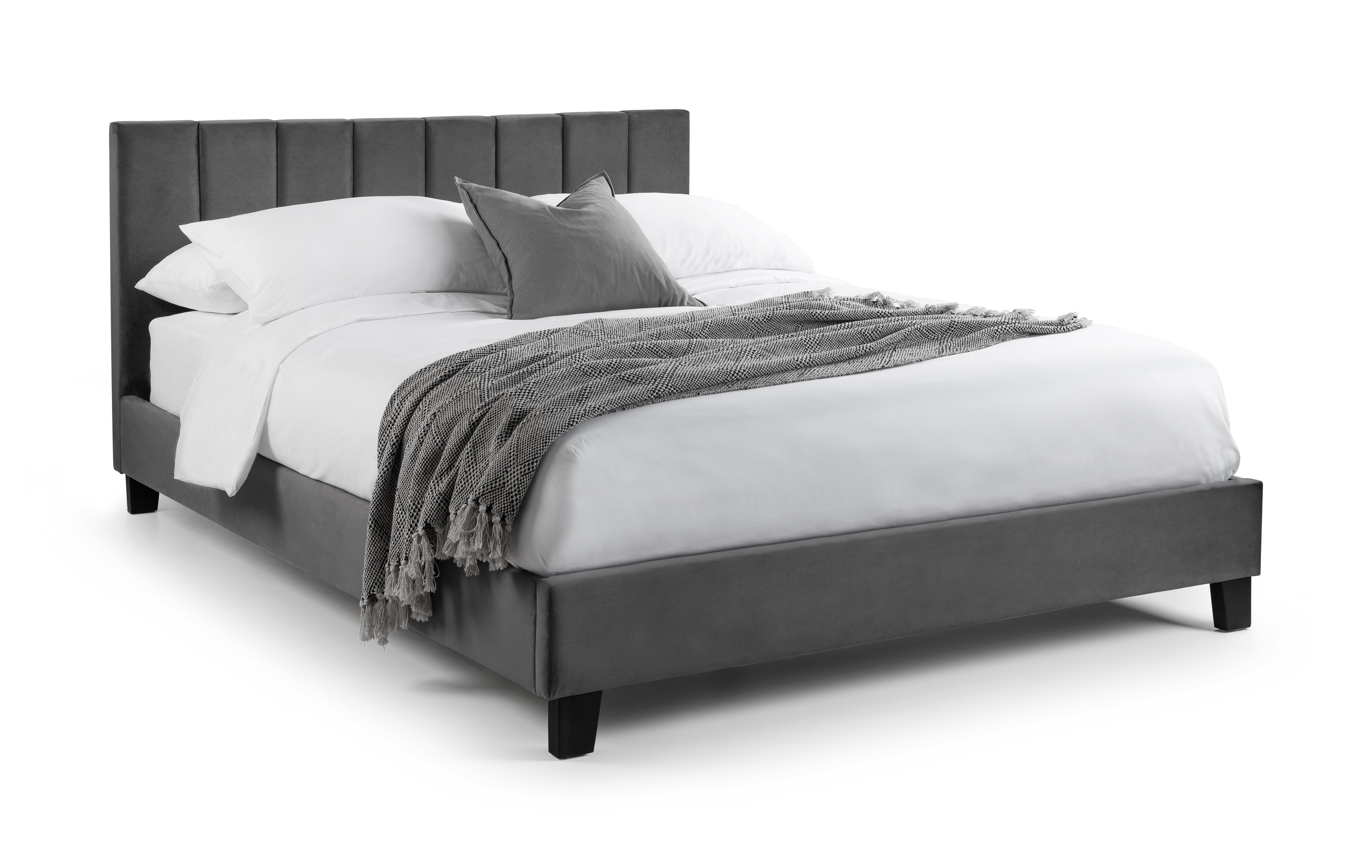 Gray upholstered bed with white bedding and gray blanket on a white background