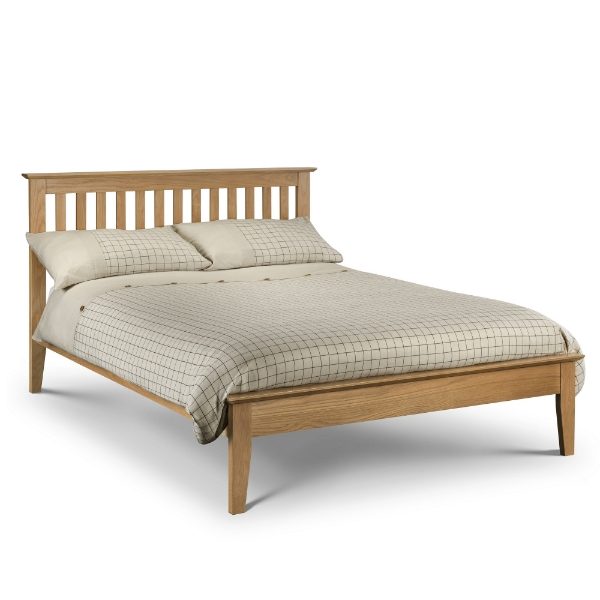 Wooden bed with checkered bedding on a white background