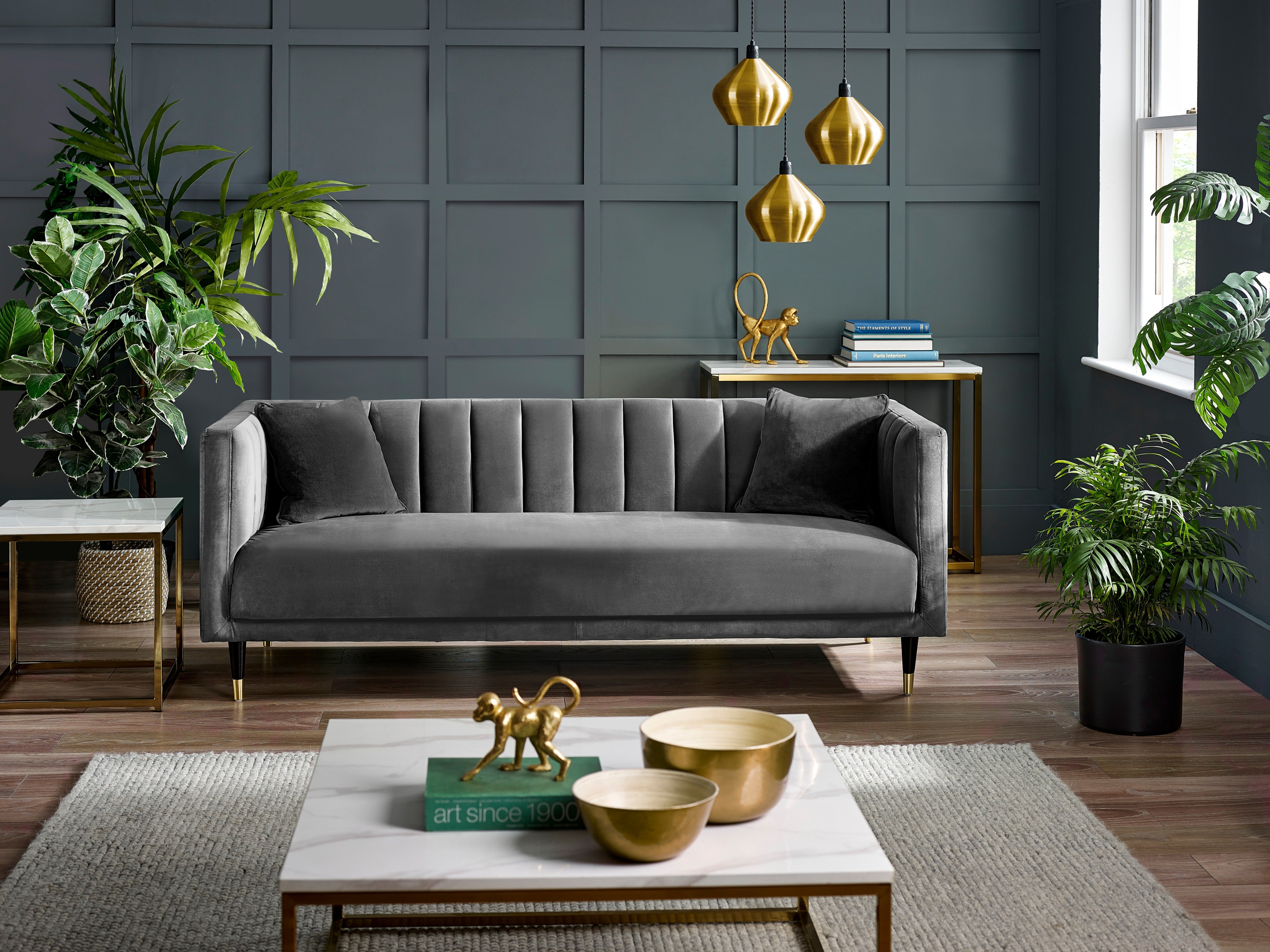 Modern living room with a gray sofa, coffee table, and decorative items.