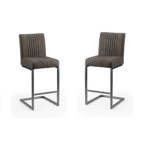 Two gray bar stools with pleated seats on a white background