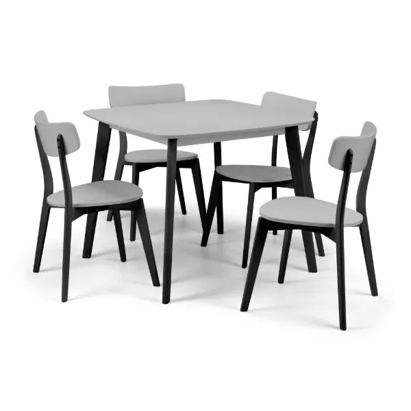 Dining table set with four chairs on a white background