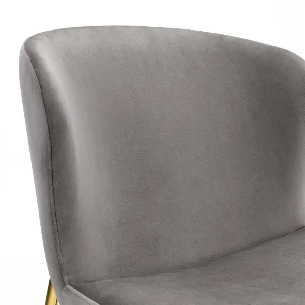 Gray upholstered chair with a gold base on a white background