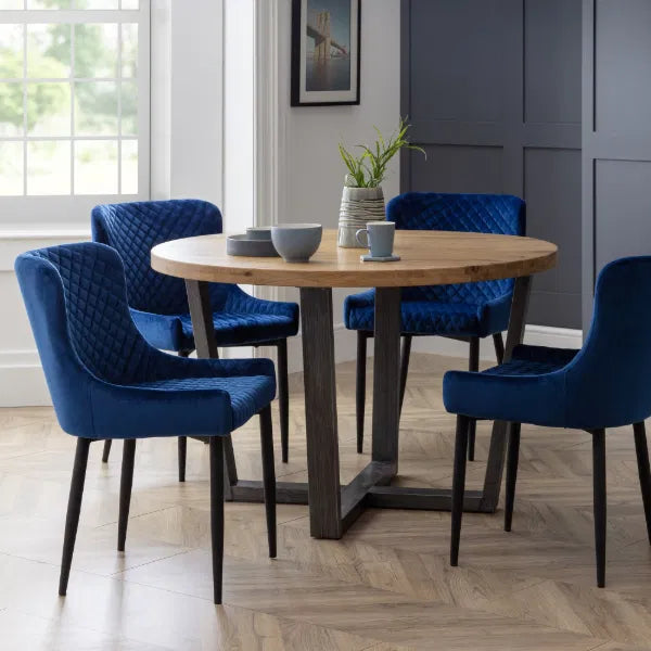 Dining room with a wooden table and blue chairs.