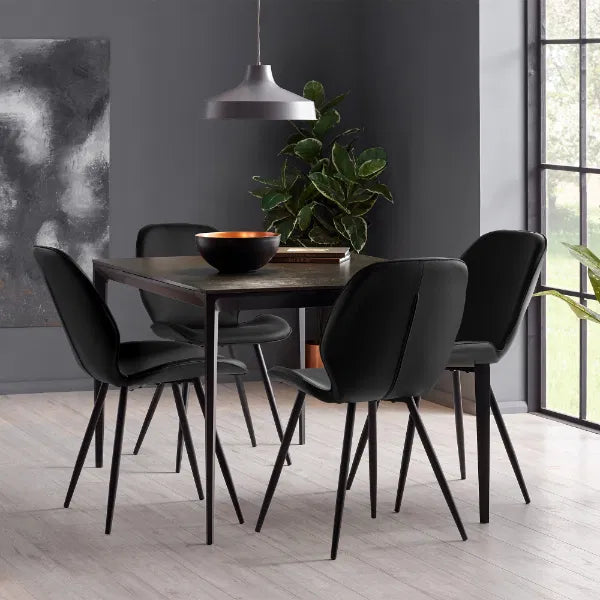 Dining room with a dark wooden table and black chairs against a gray wall.