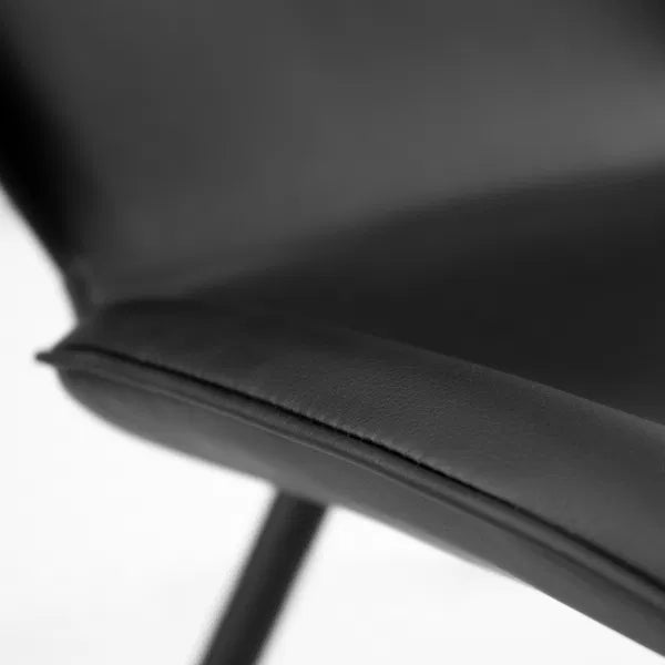 Close-up of a black chair with a blurred background