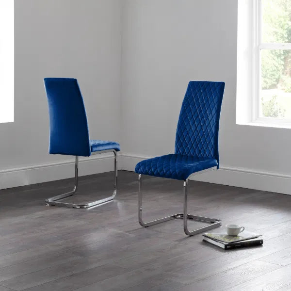 Two blue chairs on a gray floor with a neutral background
