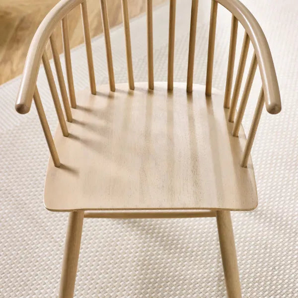 Wooden chair with a light finish on a textured surface