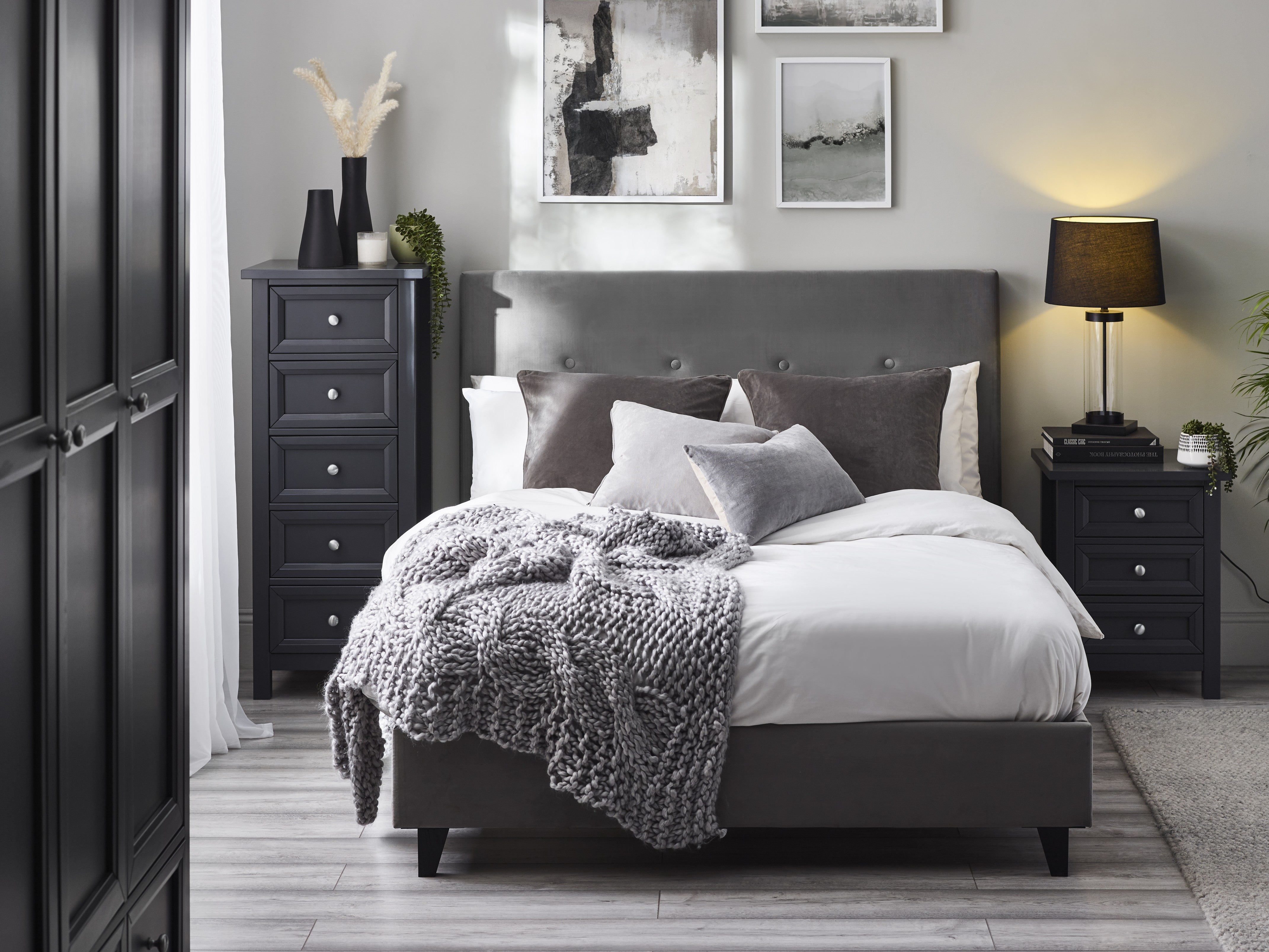 Modern bedroom with a bed, nightstands, and dresser.