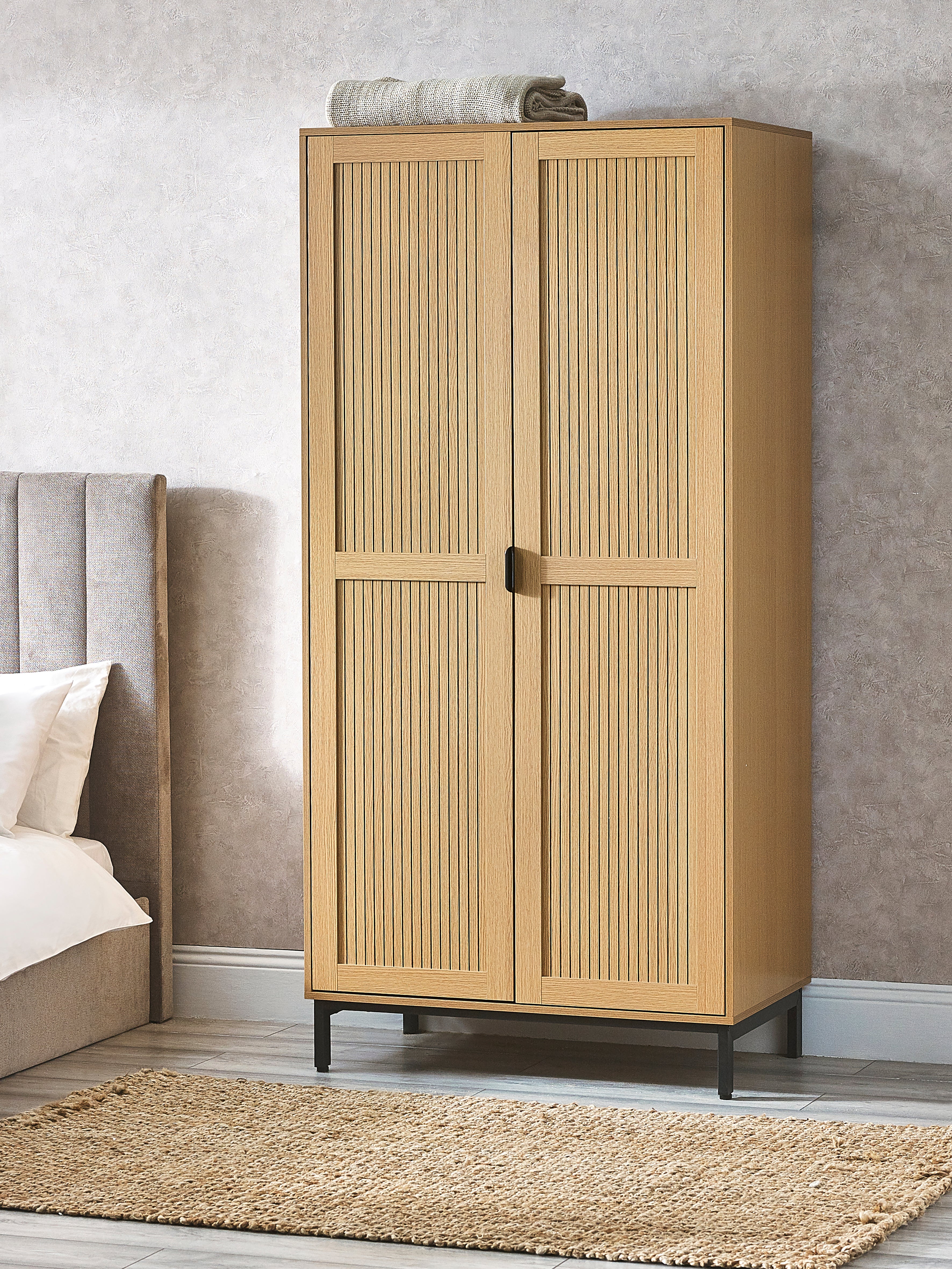 Beige wardrobe with two doors in a bedroom setting