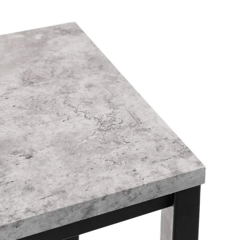Concrete-style table top with black metal legs on a white background