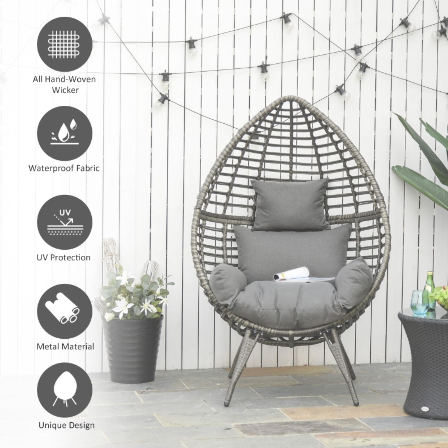 Wicker egg-shaped chair with cushions on a patio, surrounded by plants and outdoor decor.