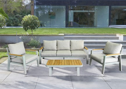 Outdoor patio set with chairs and a table on a patio area.