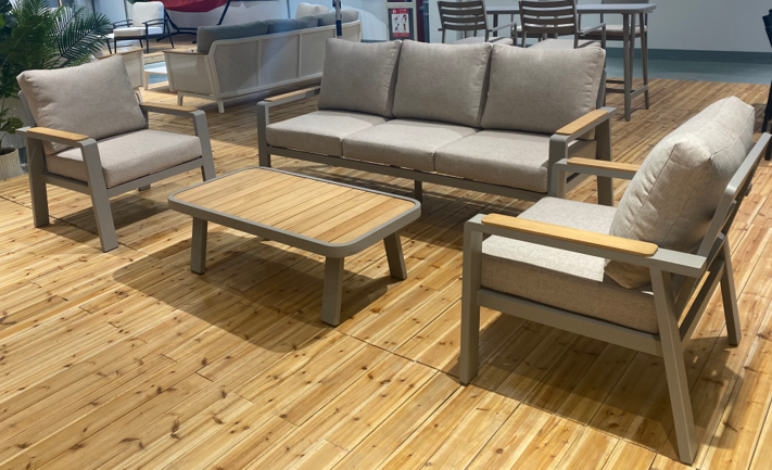Outdoor furniture set with sofa, chairs, and table on a wooden deck