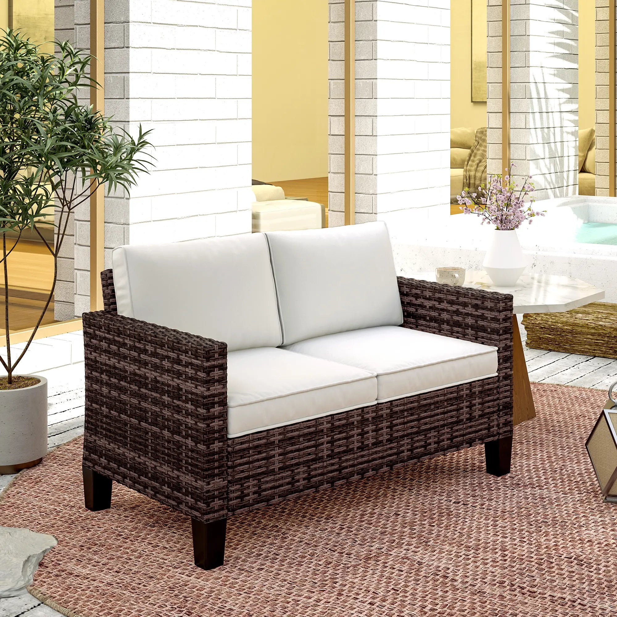 Wicker loveseat with white cushions in a modern living room setting.