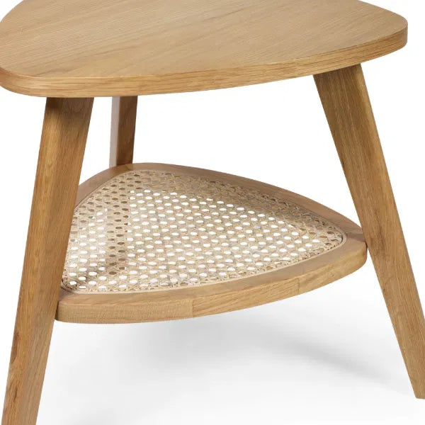 Wooden side table with wicker shelf on a white background