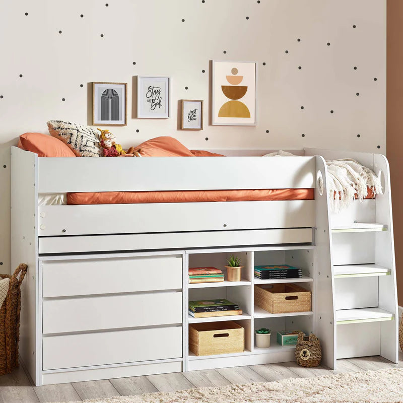 White loft bed with storage drawers and shelves in a room with polka dot walls.